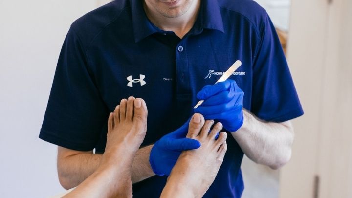 Podiatrist examining a patient’s toes during an ingrown toenail assessment.